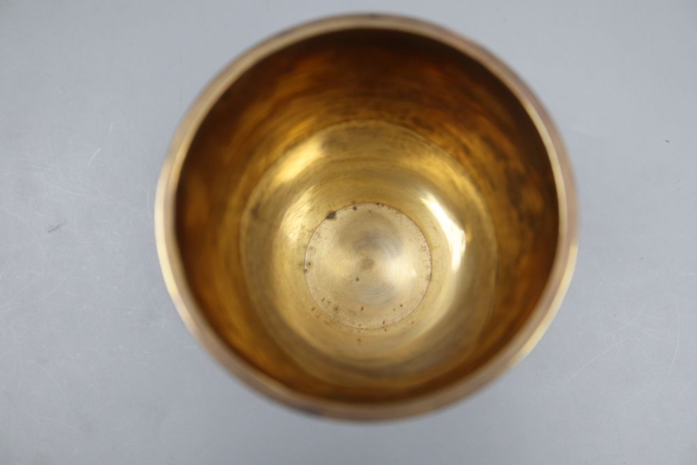 A George V silver gilt beaker, of flared form, Vander & Hedges, London 1912, 11.3cm, 6oz.